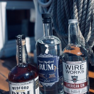 a bottle of wine on a table with Jack Daniel's in the background